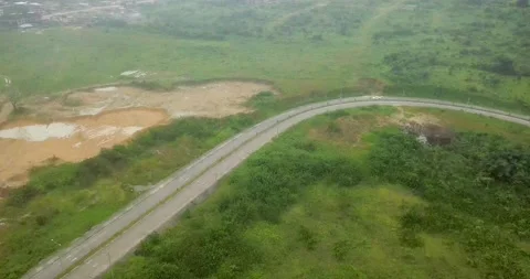 AERIAL VIEW OF THIRD WORLD LAND TRANSPORT WITH FOREST AND CARS Stock Footage 234558354