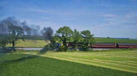 Aerial View of Thomas the Tank Engine Approaching Thru Trees and Farmlands Stock Photos
