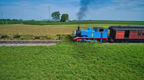 Aerial View of Thomas the Tank Engine Approaching Pulling Passenger Cars Blowing Stock Photos