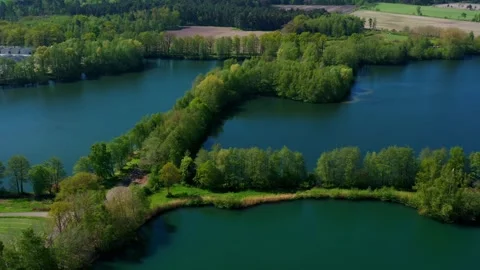 Aerial view of three artificial ponds next to an industrial plant in the fl.. Vidéo 240836065