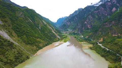 Aerial view of three branch river wide tidal flat green mountain valley farmland Stock Footage 337926619