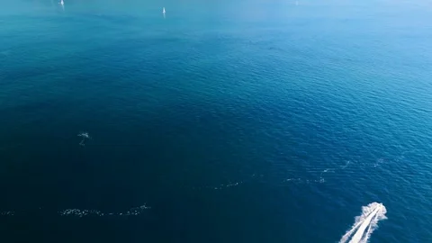 Aerial view of three fast boats on a deep blue sea with white waves Stock Footage 263402610