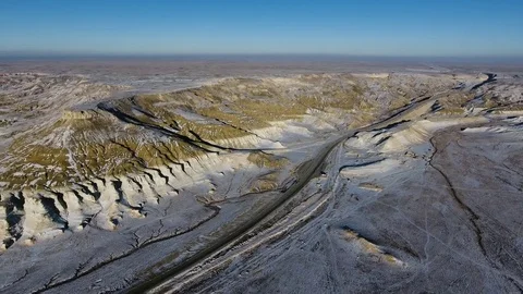 Aerial view of three suvs moving along the highway in the snow-coversd sandy Stock Footage 80246591
