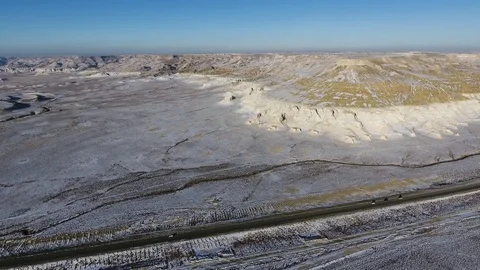 Aerial view of three suvs moving along the highway in the snow-coversd sandy Stock Footage 80984012