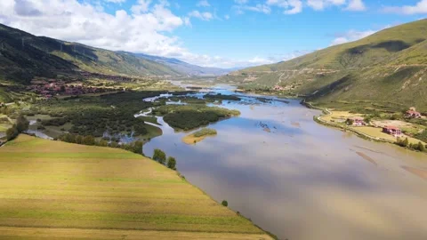 Aerial view of three way river bend gentle farmland river valley mountain Stock Footage 337926349