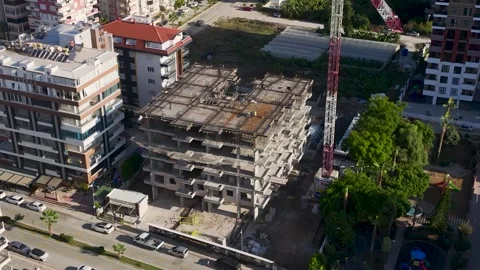 Aerial View: A thriving construction site features workers laying bricks and Stock Footage 296062957
