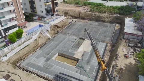 Aerial View: A thriving construction site with foundation insulation and Stock Footage 296097787