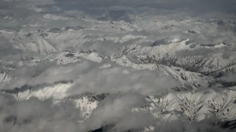 Aerial view through an airplane window, fly over snow Caucasian mountains Stock Footage 60621945