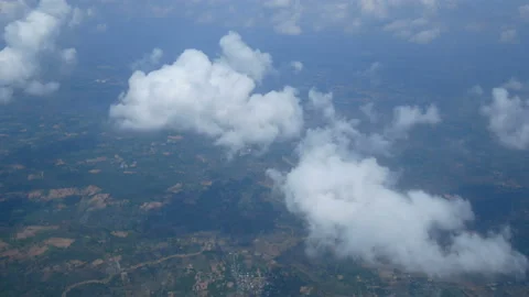 Aerial view through an airplane window. beautiful white clouds in blue sky Stock Footage 133627336