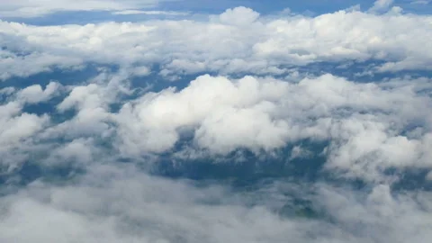 Aerial view through an airplane window. beautiful white clouds in blue sky Stock Footage 134168268