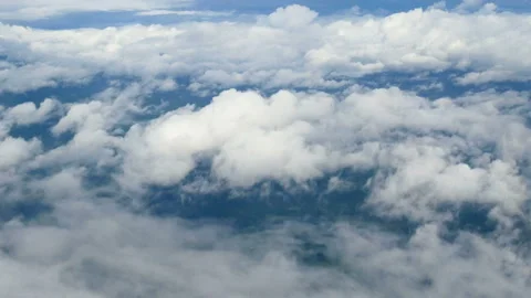 Aerial view through an airplane window. beautiful white clouds in blue sky Stock Footage 134826628