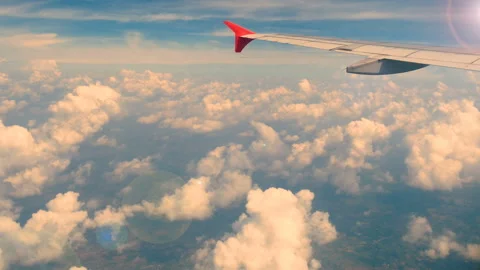 Aerial view through an airplane window. wing airplane at sunset or sunrise time Stock Footage 135245090