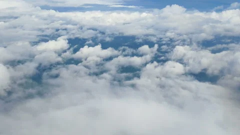 Aerial view through an airplane window. beautiful clouds in blue sky background Stock-Footage 135245174