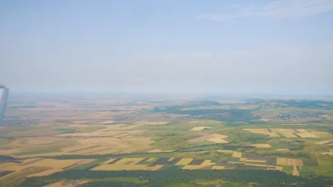 Aerial view through an airplane window showing fields and countryside in Po.. Stock Footage 294338818