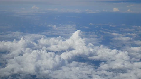 Aerial view through an airplane window.white clouds in blue sky. Stock Footage 135334047