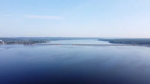 Aerial view through a big water reservoir surrounded by trees. Stock Footage 247166076
