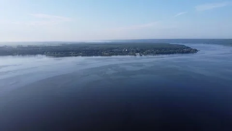 Aerial view through a big water reservoir surrounded by trees. Nature reflected Stock Footage 247537985