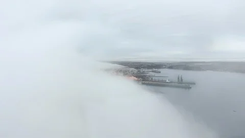 Aerial view through a cloud to a pier in a coastal town (Quebec, Canada) Video stock 120650184