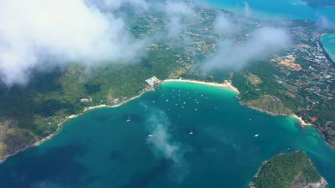 Aerial view through clouds of Phuket Island, Nai Han Beach with ships, Thailand Stock Footage 173379072