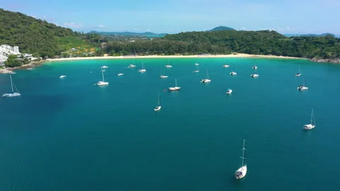 Aerial view through clouds of Phuket Island, Nai Han Beach with ships, Thailand Stock Footage 219498944