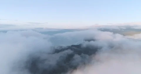 An aerial view through clouds towards the West Coast at Gillespie Beach. New Stock Footage 100124371