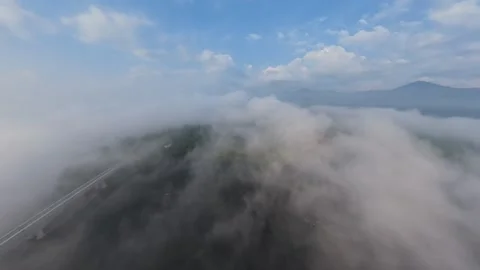 Aerial view through drifting clouds over hills Vídeos de archivo 344822946
