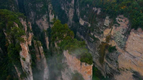 Aerial View Through Mist Of Towering Sandstone Cliffs On Rainy Day At 動画素材 329640571