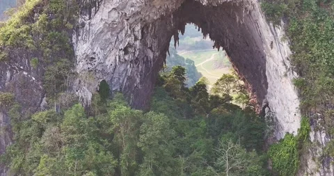 Aerial View Through Natural Limestone Rock Arch in Cao Bang Vietnam 스톡 동영상 332016555