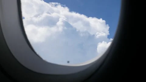 Aerial view through plane window with view over puffy white cloud with clea.. Stock Footage 246469766