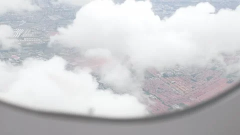 Aerial view through plane window frame over puffy white cloud and countrysi.. Stock Footage 297455466