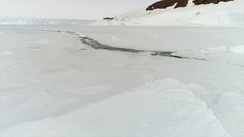Aerial view. Thrown broken plane lies in the snow. Antarctica Stock Footage 119564194