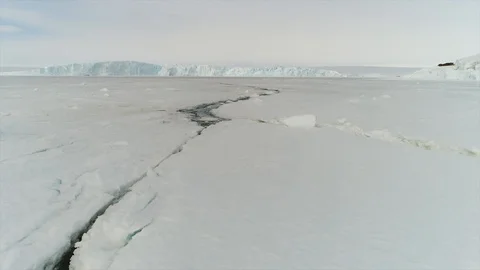 Aerial view. Thrown broken plane lies in the snow. Antarctica Stock Footage 119564570