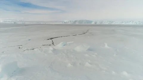 Aerial view. Thrown broken plane lies in the snow. Antarctica Stock Footage 119565337