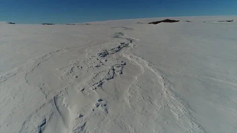 Aerial view. Thrown broken plane lies in the snow. Antarctica Stock Footage 119574639