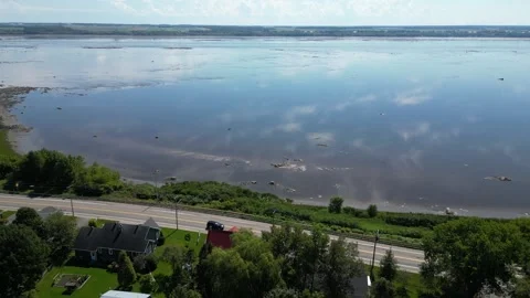Aerial View of Tidal Flats Along a Quebec Riverside Road Vídeos de archivo 338325322