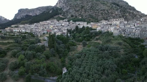 An aerial view of a tightrope walker walking above a deep valley. Video stock 342394105