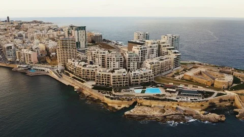 Aerial view of Tigne Point complex in  Sliema city. Camera move back. Malta Stock Footage 103792469