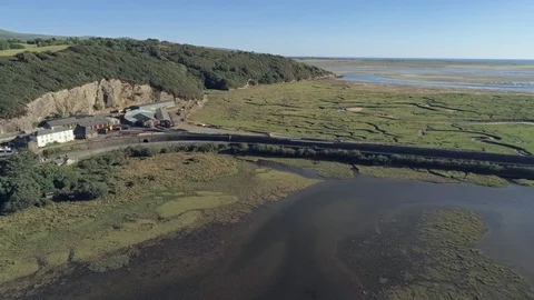 Aerial view, tilt down move. Drone panorama over Glaslyn wetlands, bridge and Stock Footage 94244310