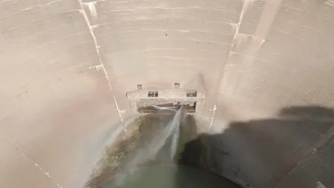 Aerial view tilt down of old huge dam with water leakage Stock Footage 260465784