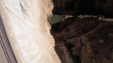 Aerial view tilt down of old huge dam with water leakage Stock Footage 260465820