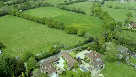 Aerial view tilt down over idyllic countryside farm property patchwork Stock Footage 166249609
