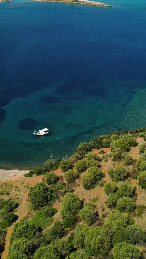 Aerial view tilting up over turquoise sea and beach in Greece Stock Footage 342238665