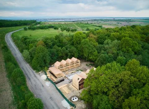 Aerial view of timber housing development in forest landscape near countrys.. Stock Photos