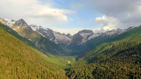 Aerial view time lapse clouds float over mountain peaks. Video stock 156346677