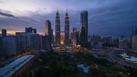 Aerial view time lapse of Kuala Lumpur skyscrapers and landmarks during sunset Stock Footage 99784520