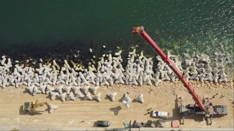 Aerial view timelapse of Construction of a new breakwater by heavy duty crane Stock Footage 236710174