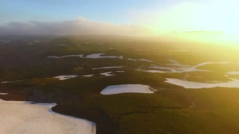 Aerial View. timelapse. Fast flying over the green valley. Sunset in the Stock Footage 72998399