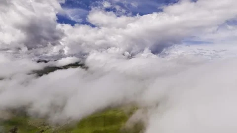 Aerial view timelapse of parallax clouds over a mountainous area. Videos summer Stock Footage 246135634