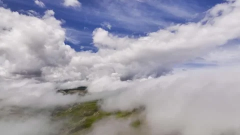 Aerial view timelapse of parallax clouds over a mountainous area. Videos summer Stock Footage 246135798