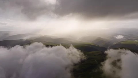 Aerial view timelapse of parallax clouds over a mountainous area. Videos summer Stock Footage 246138276